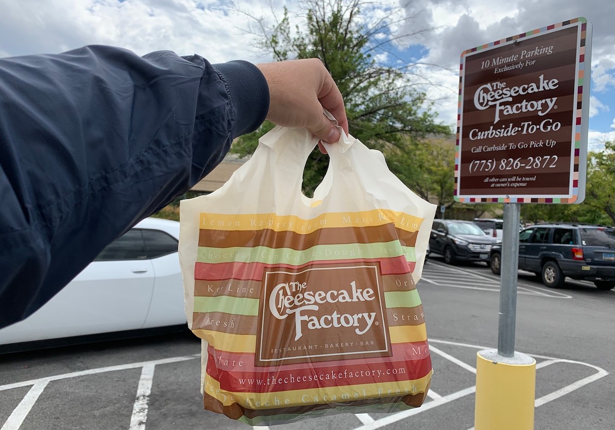 curbside pick up sign with cheesecake factory leftovers bag