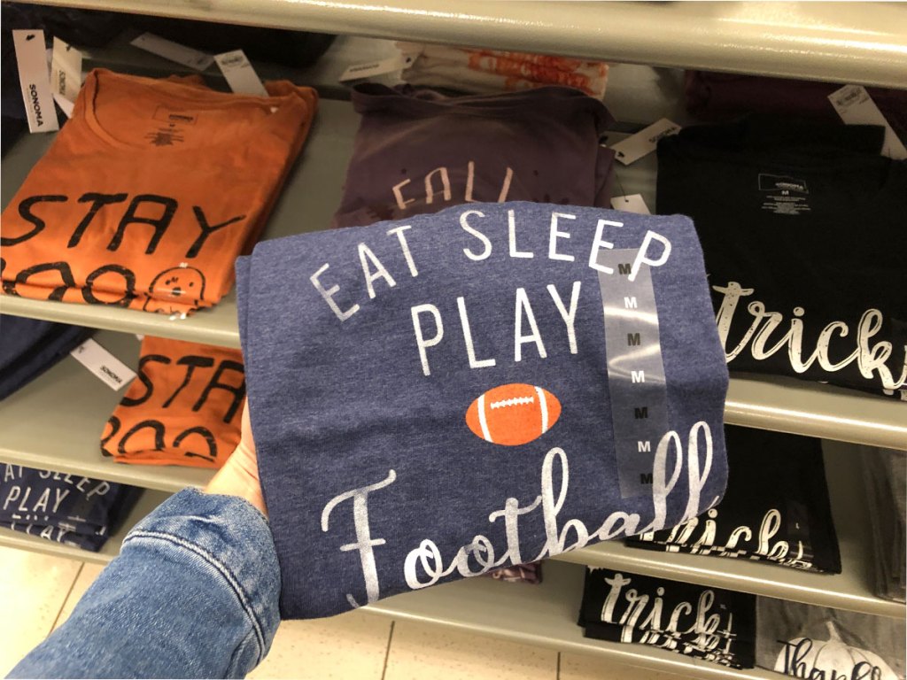 hand holding eat-sleep-play-football tee