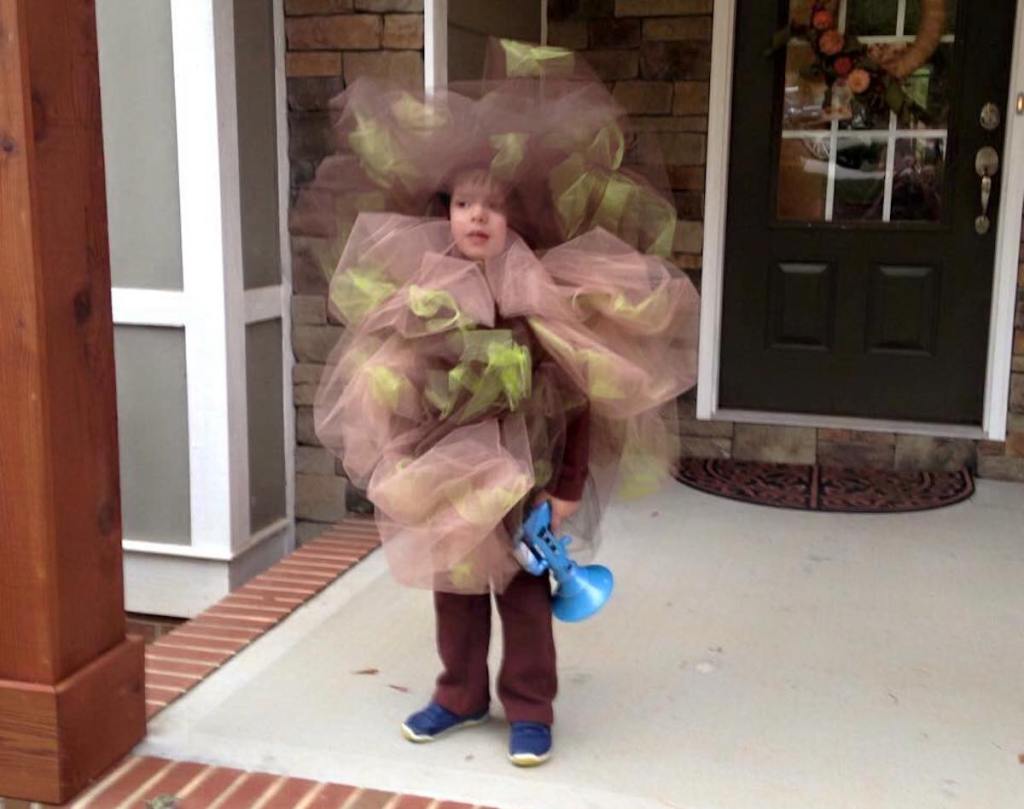 kid wearing fart costume on porch