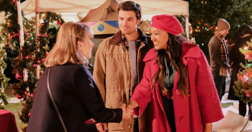 two women shaking hands in Christmas movie