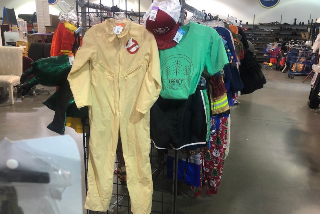 two kids diy halloween costumes hanging on end of clothing rack at store
