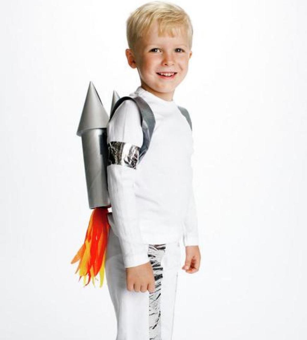 boy wearing white rocket ship man costume