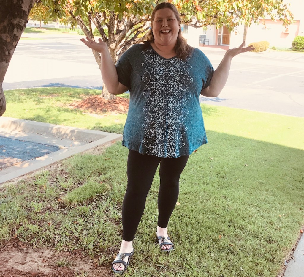 woman wearing black leggings and floral shirt with sandals