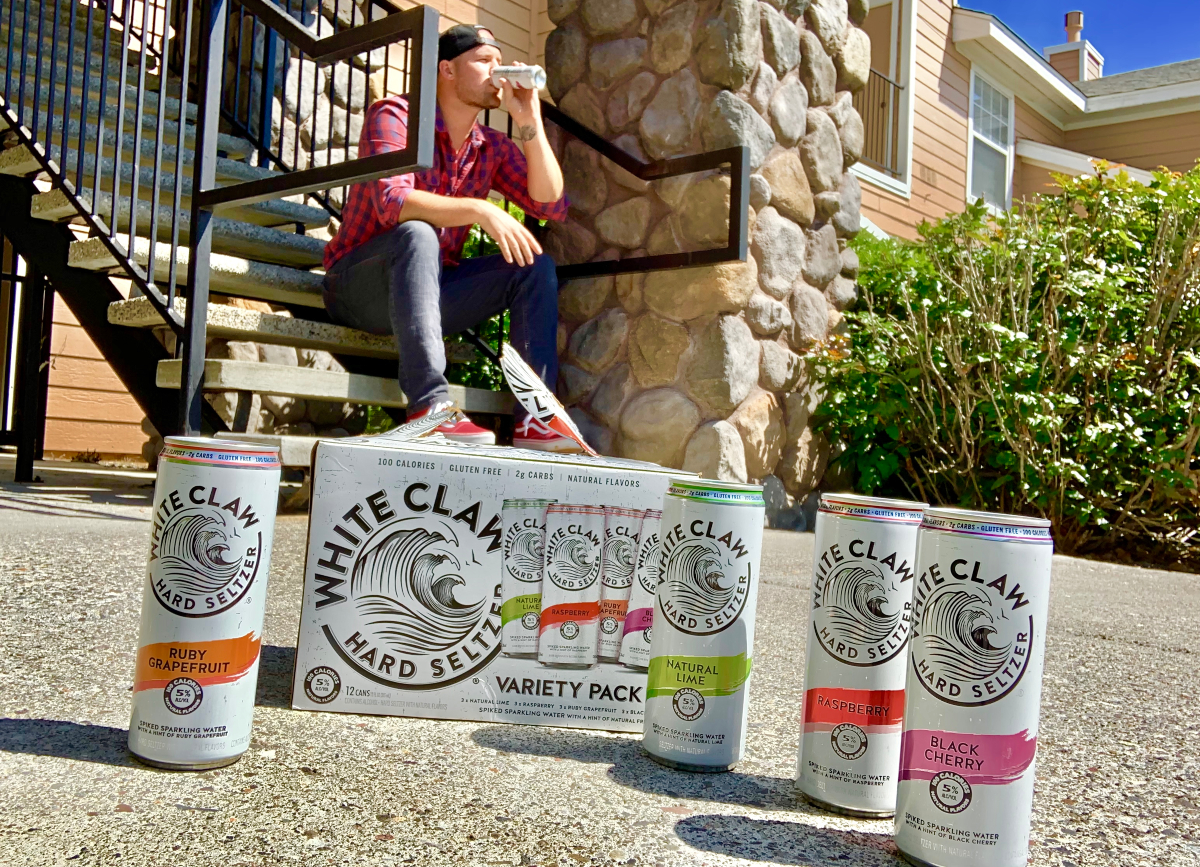 Stetson drinking white claw on steps