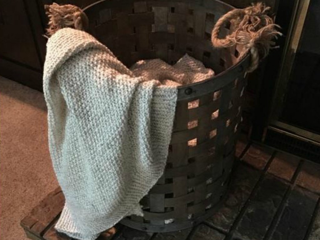 blanket laying over bucket by fireplace