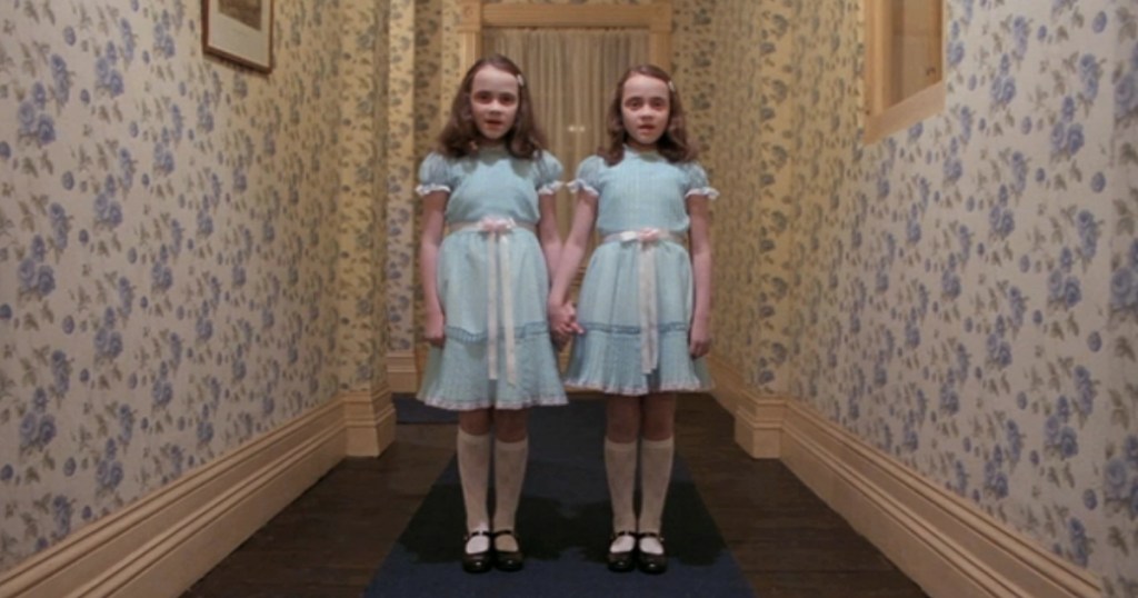 The Shining twins in a dark hallway