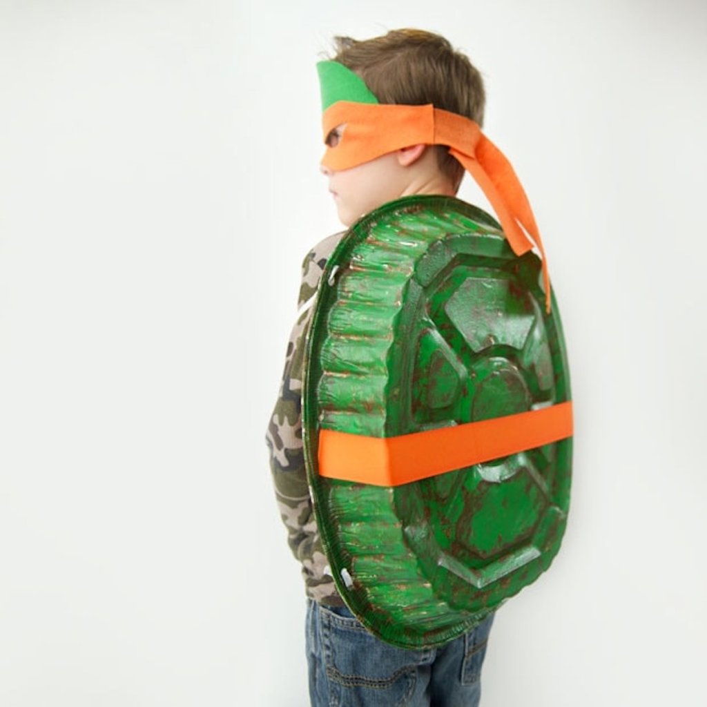 boy wearing orange ninja turtle costume