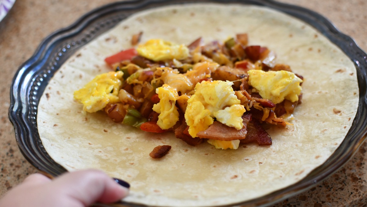 warming up a breakfast burrito pouch in a tortilla