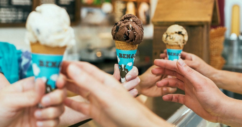 3 People taking Ben & Jerry's Ice Cream Cones from worker