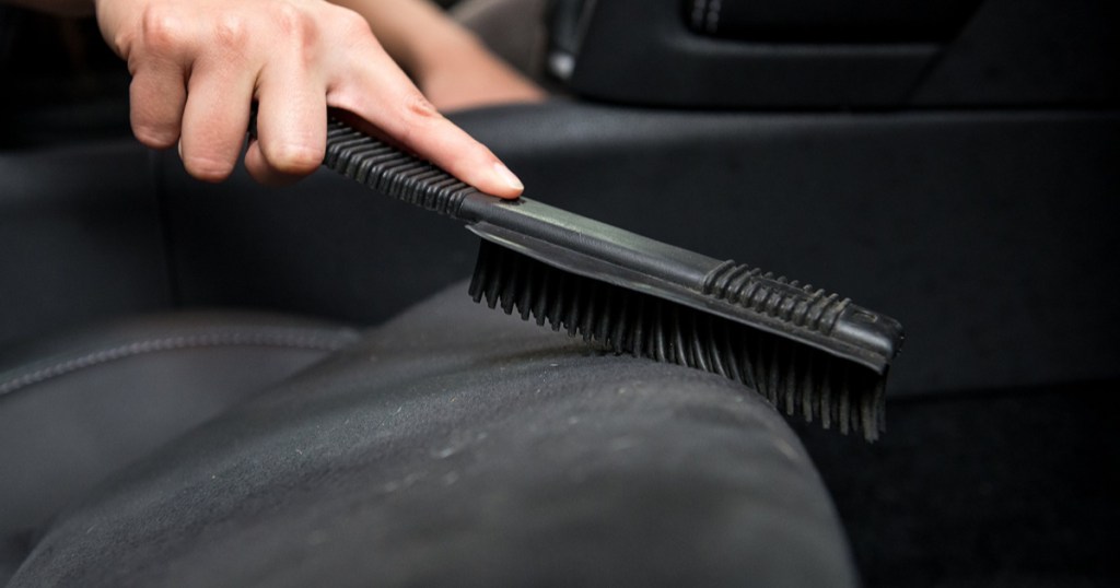 Hand holding Chemical Guys Cleaning Brush
