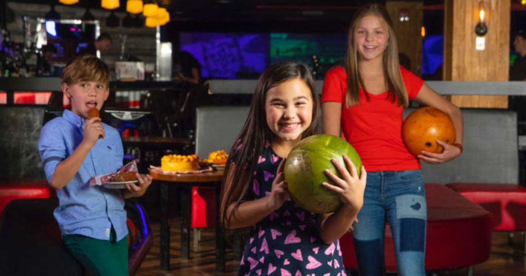 CertifiKID Kids holding bowling balls at bowling ball