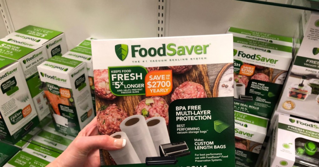 hand holding up box of food saver rolls