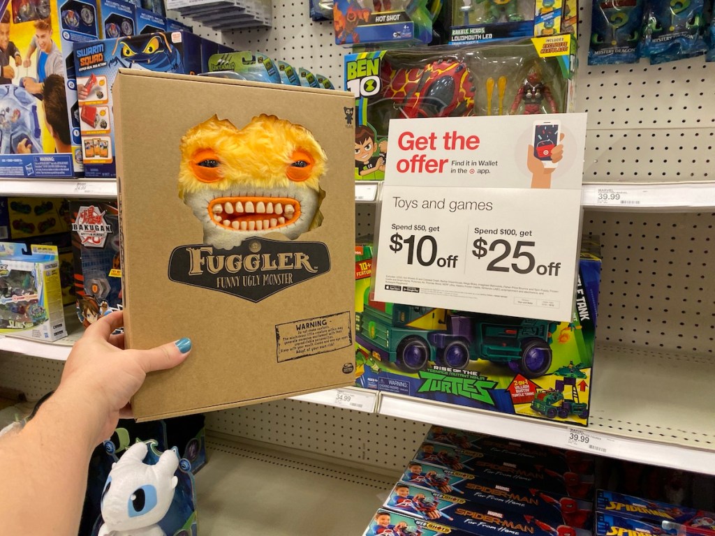 hand holding Fuggler by Target sign