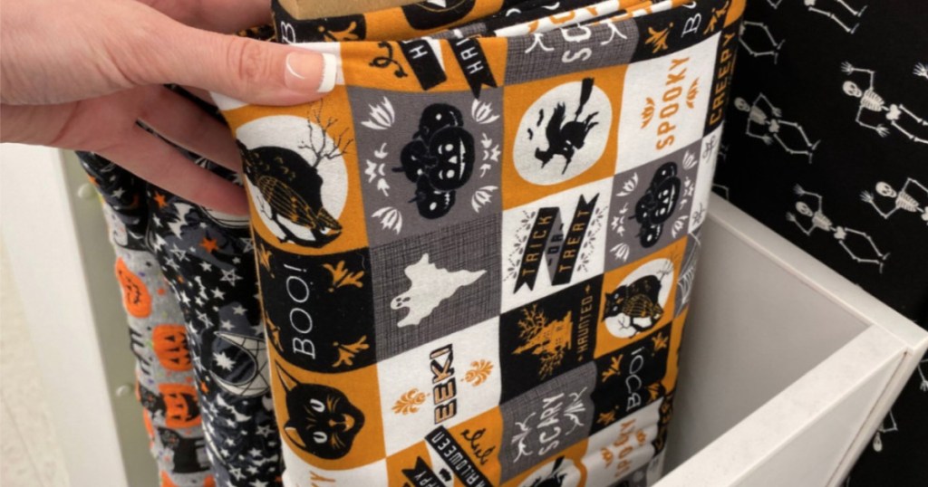 hand holding up halloween fabric