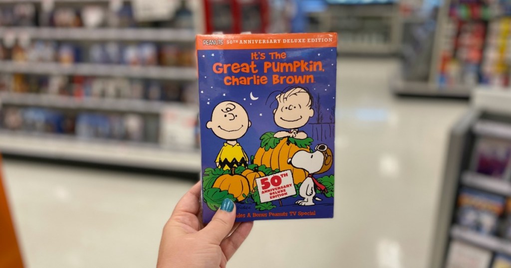 woman holding It's the Great Pumpkin, Charlie Brown 50th Anniversary Edition DVD at Target