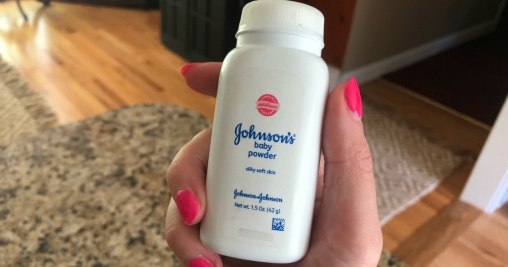 Woman holding bottle of Johnson's Baby Powder