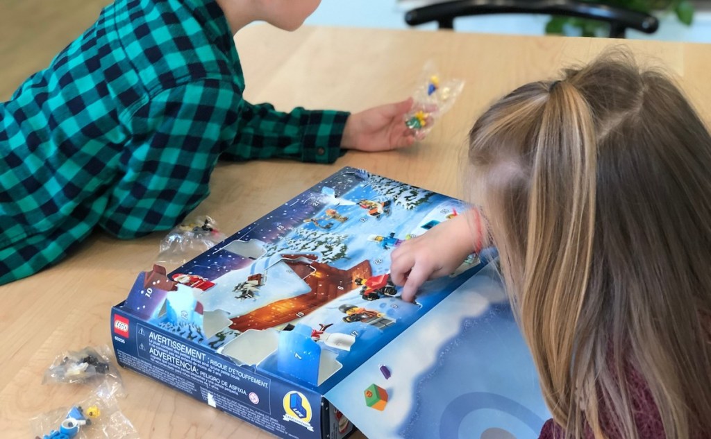 two kids playing with lego advent calendar