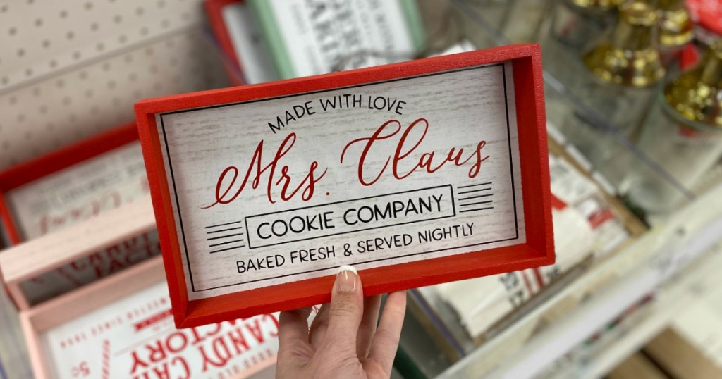 Red tabletop sign for Christmas in hand in Target