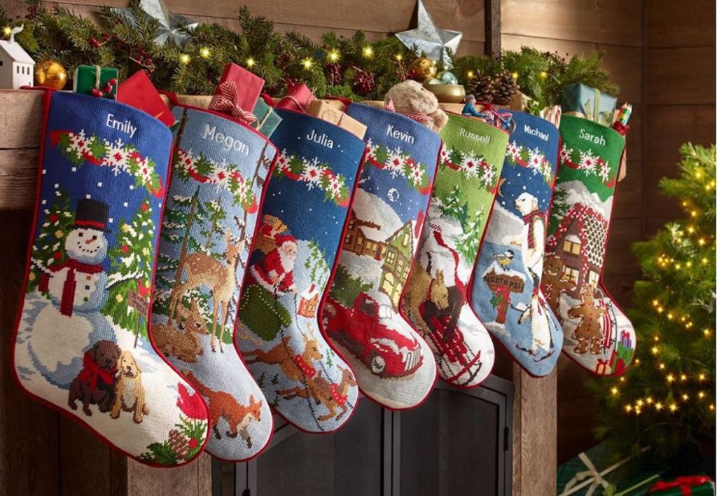 row of traditional christmas stockings hanging on a mantel