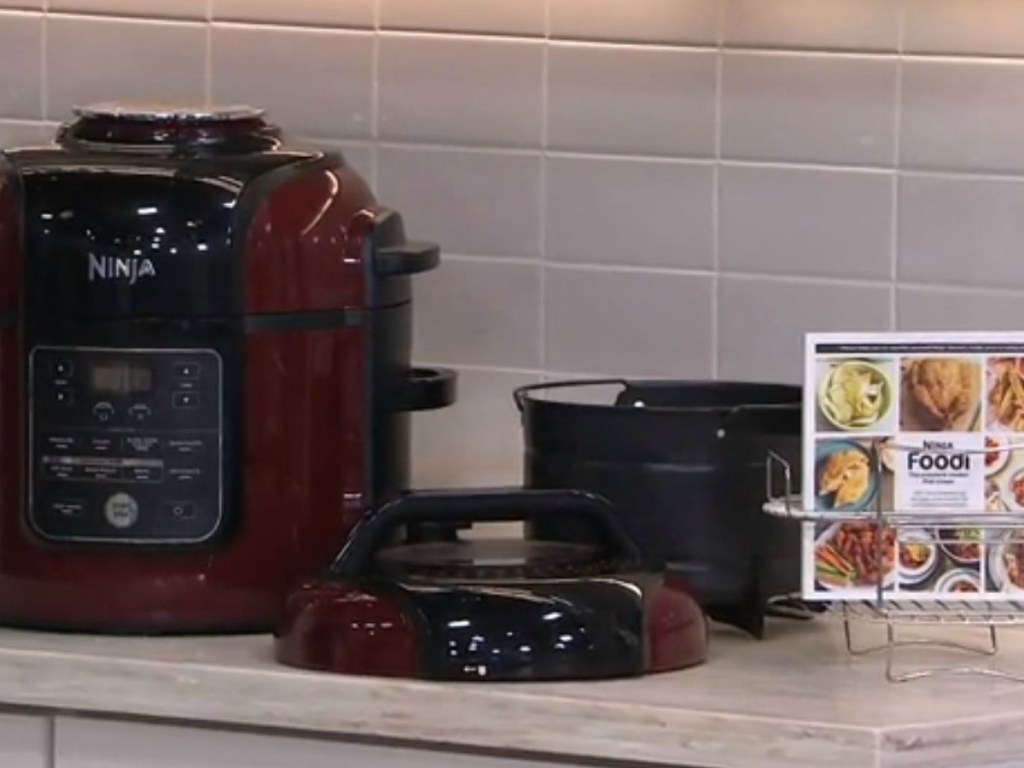 red kitchen appliance with cookbook