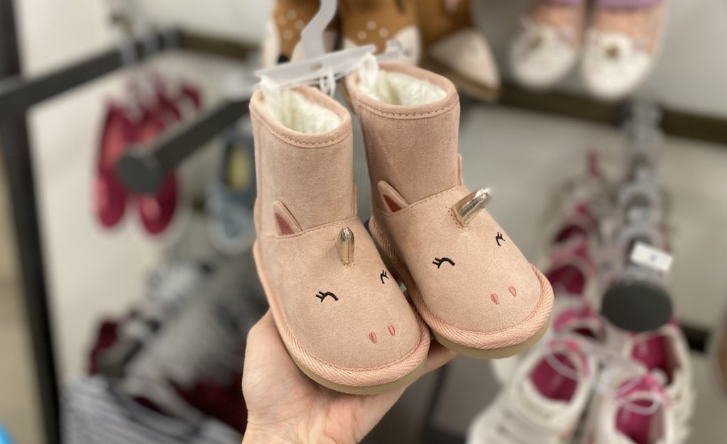 hand holding Old Navy Unicorn Boots