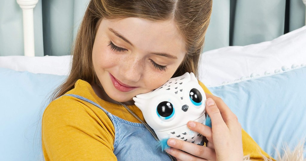 girl cuddling owleez flying baby owl toy