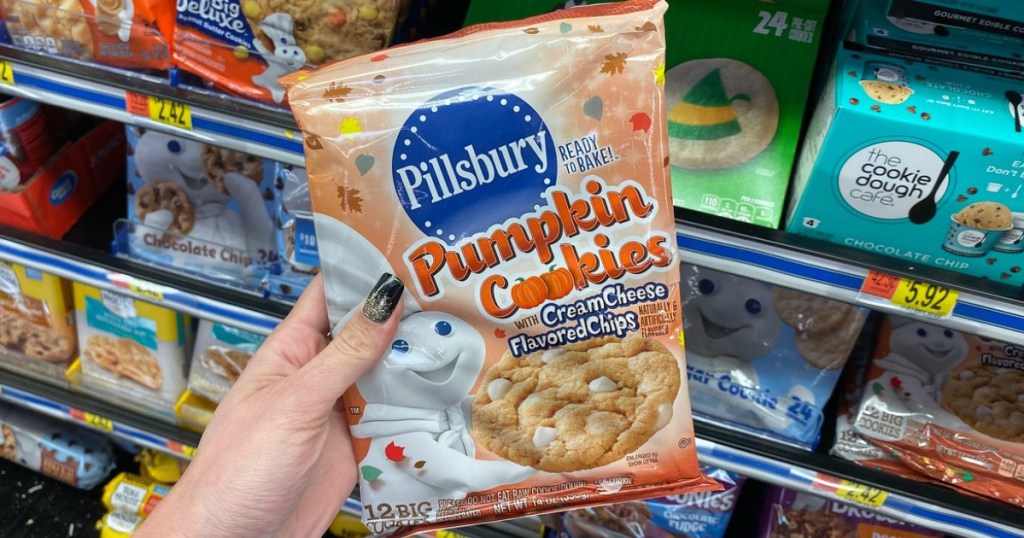 woman holding Pillsbury Pumpkin cookies