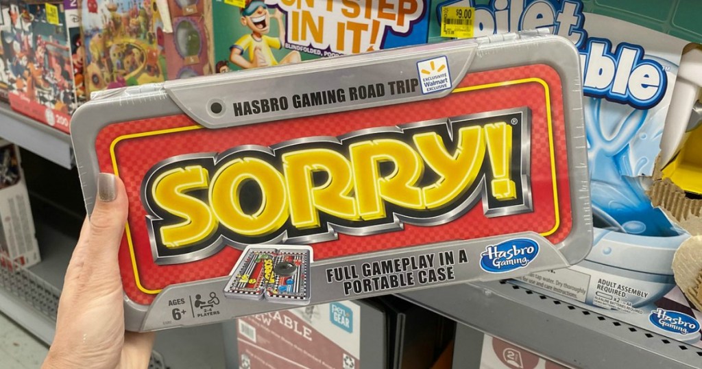 woman holding SORRY! travel game