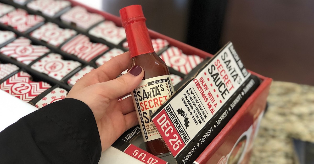 hand holding bottle of santa's secret sauce 