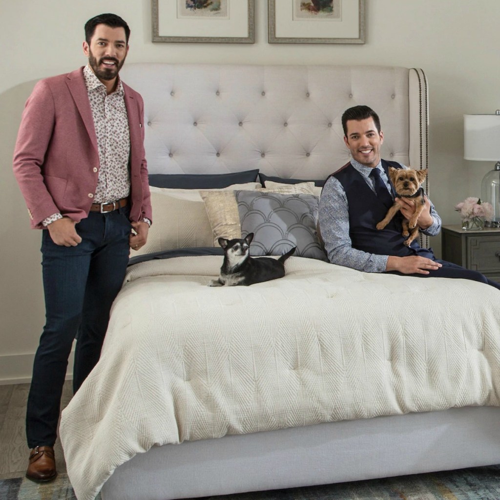 Scott Living Luxe Deco Fan Comforter Set in ivory color on bed with the Scott brothers and their dogs