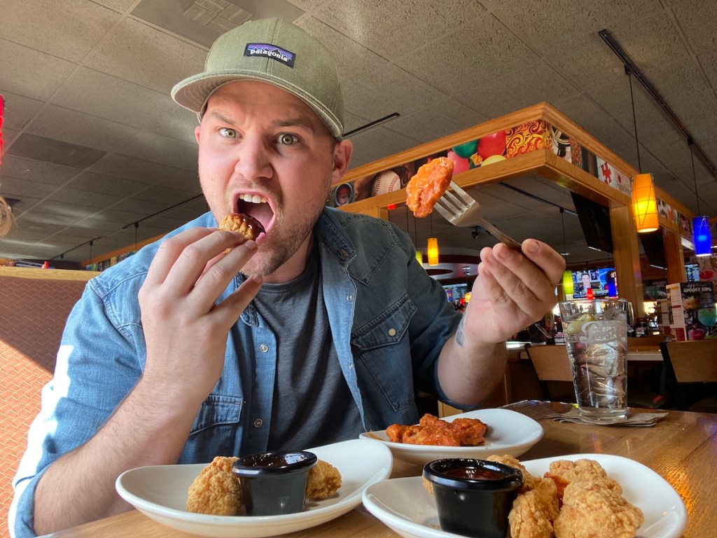 Man eating wings at Applebee's
