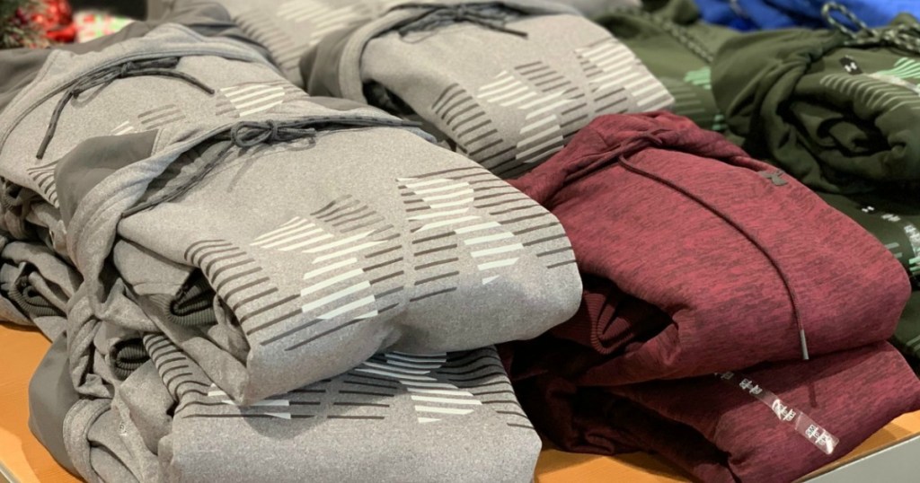 Men's UA Hoodies folded and stacked on display at Dick's Sporting Goods