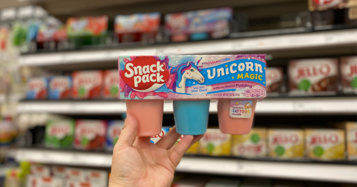 hand holding up unicorn magic snack pack pudding