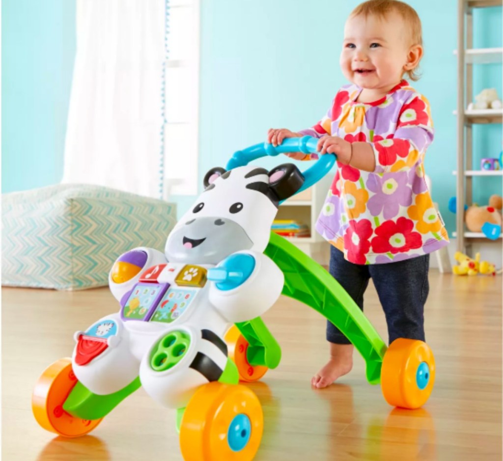 baby pushing a Fisher Price Walker