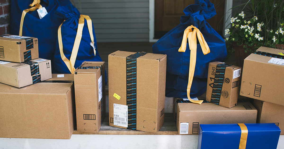 Amazon boxes and gift wrapped packages on front porch