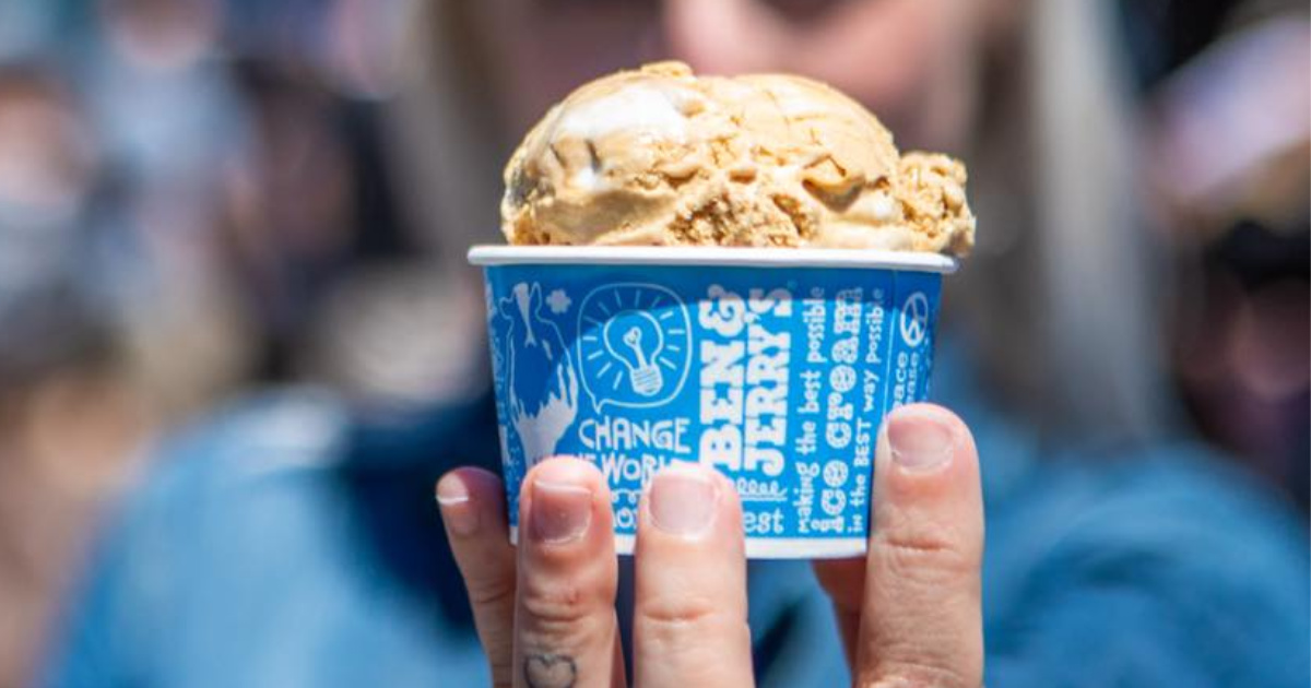 person holding cup of Ben & Jerry's ice cream