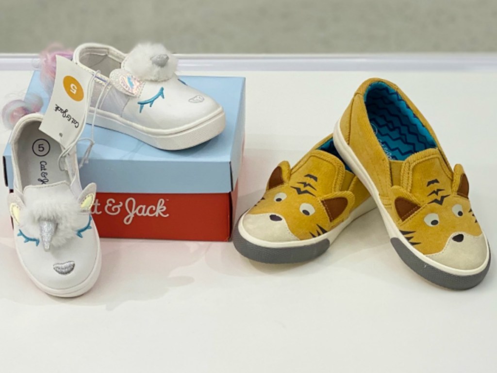 little pair of white shoes and tiger orange kids shoes
