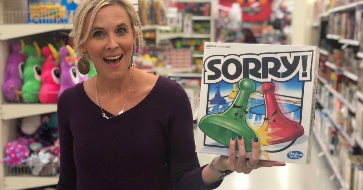 woman holding sorry board game in store