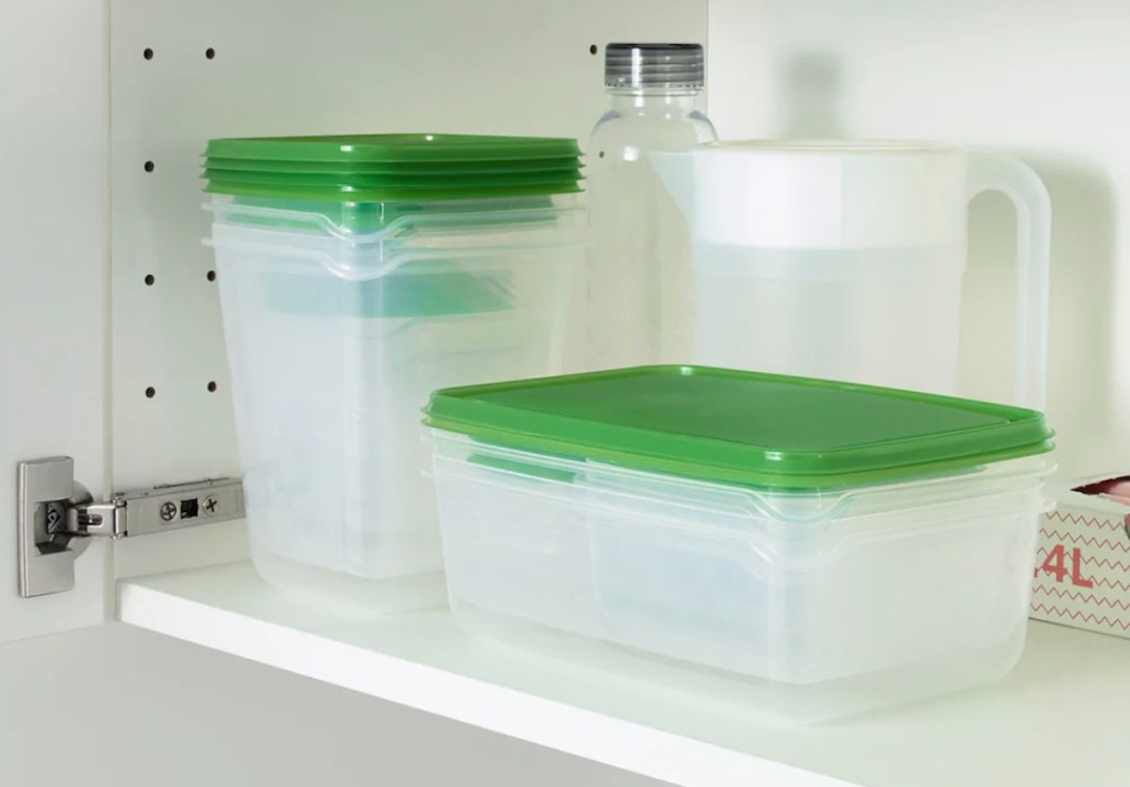 green and clear food containers stacked inside cabinet