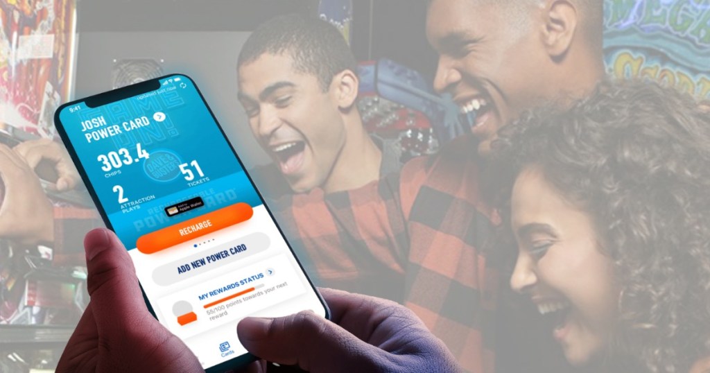 hand holding phone with people in background smiling