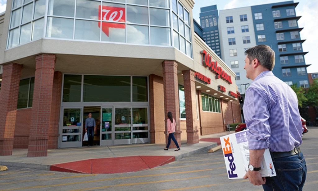 Man carring FedEx package into Walgreens
