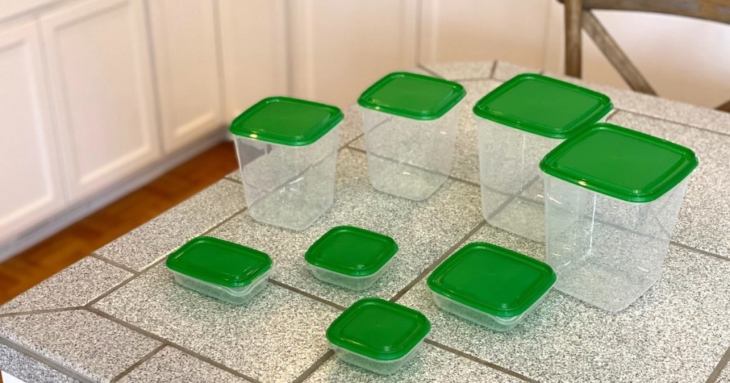 green and clear food containers sitting on gray tiled counter