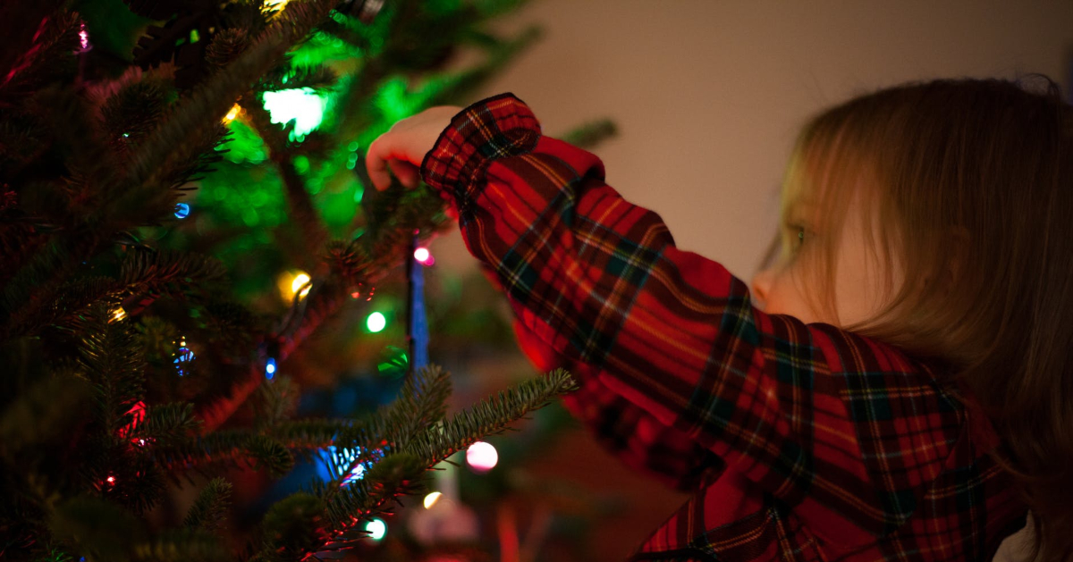 Girl decorating Christmas tree