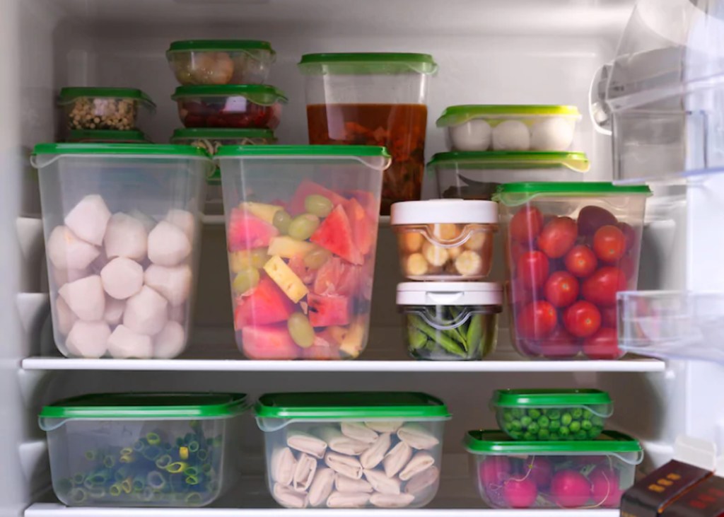 green and clear ikea food containers with food stacked in fridge