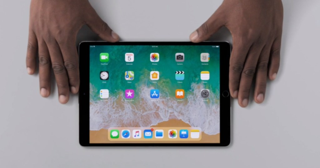 hands holding iPad