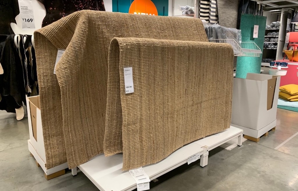 two jute rugs hanging in IKEA store