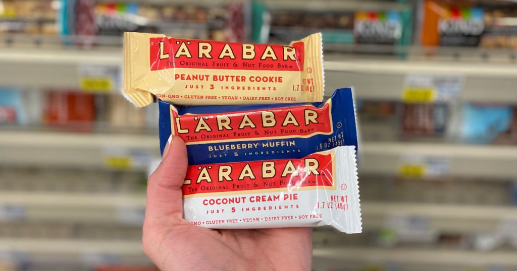 hand holding three different flavors of larabars in cvs