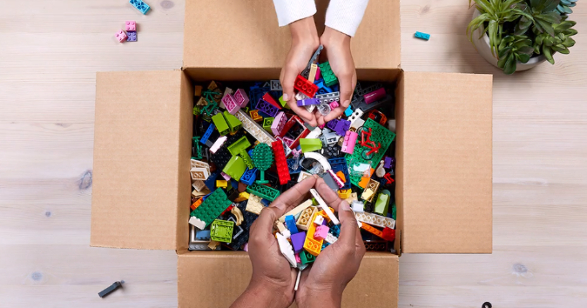 hands putting LEGOs in box for LEGO Replay program