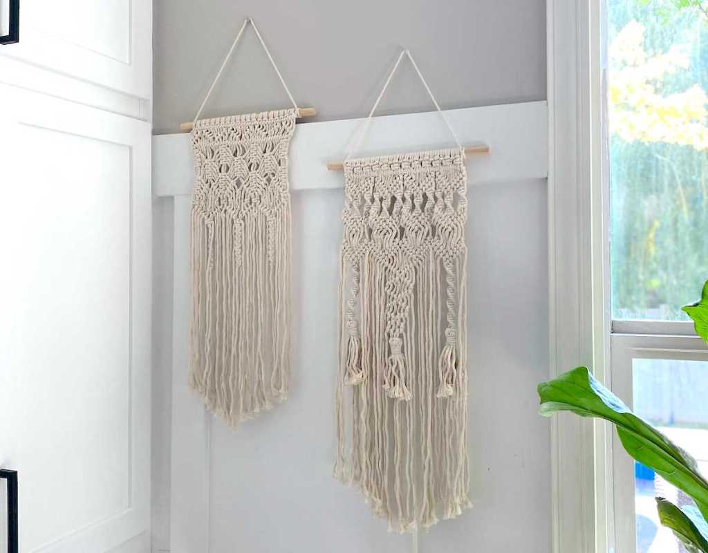 two macrame hanging wall pieces on white wall