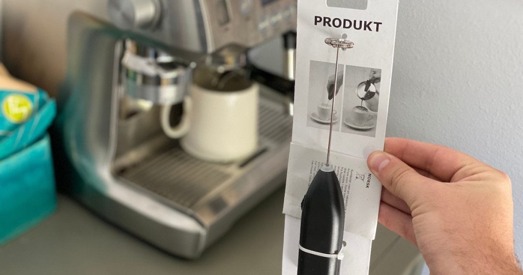 hand holding ikea milk frother in packaging